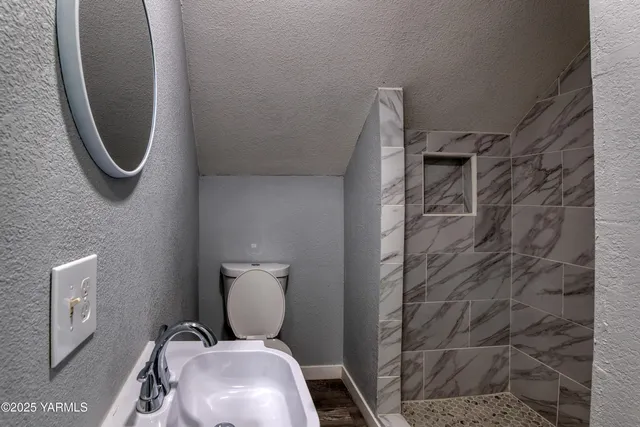 a bathroom with a toilet and a sink