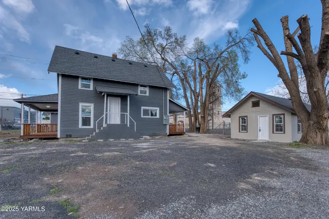 a front view of a house with a garden