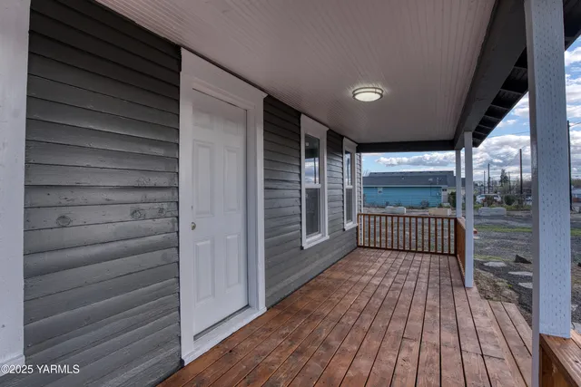 a view of a porch with wooden floor and windows