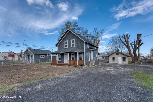 a wooden house with a large window and wooden fence