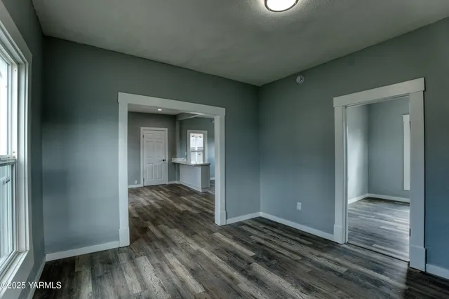 a view of hallway with wooden floor