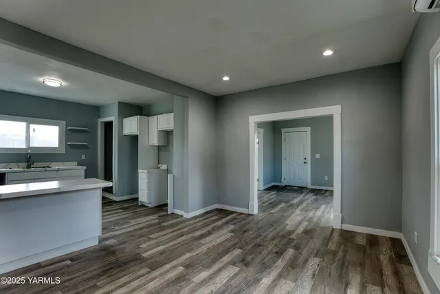 a view of a big room with wooden floor and furniture