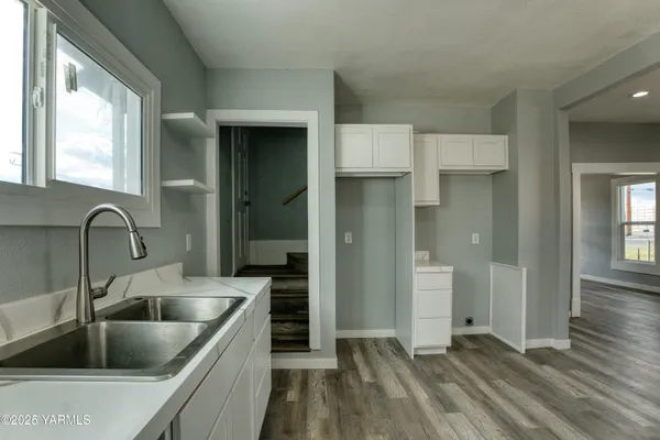 a kitchen with kitchen island a sink appliances and cabinets