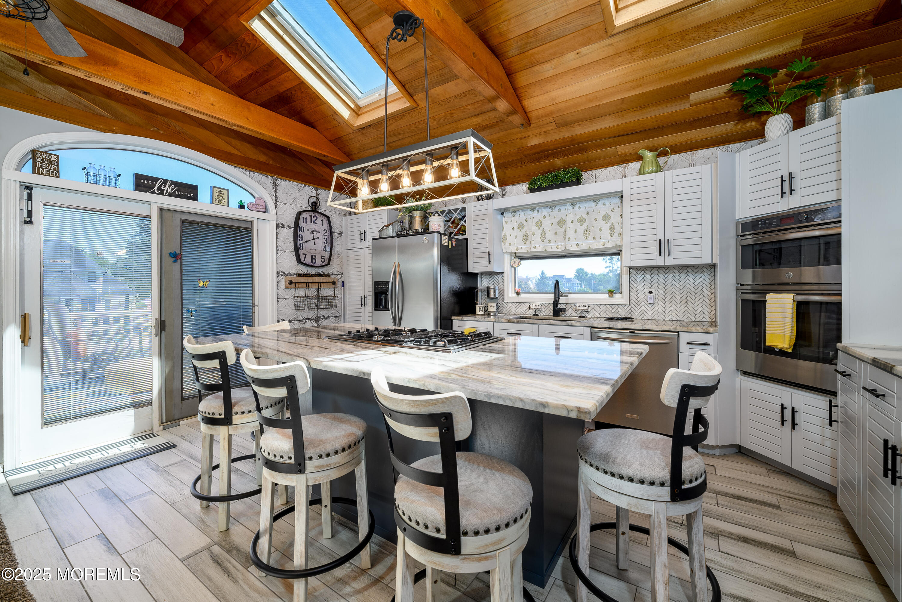 109 West Island Road Bayville, NJ 08721 - Photo 11 of 38 a open kitchen with a table and chairs