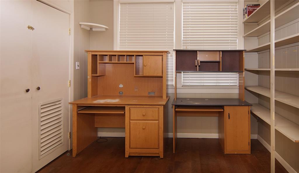 730 Indiana Street Graham, TX 76450 - Photo 11 of 25 a kitchen with stainless steel appliances cabinets and wooden floor
