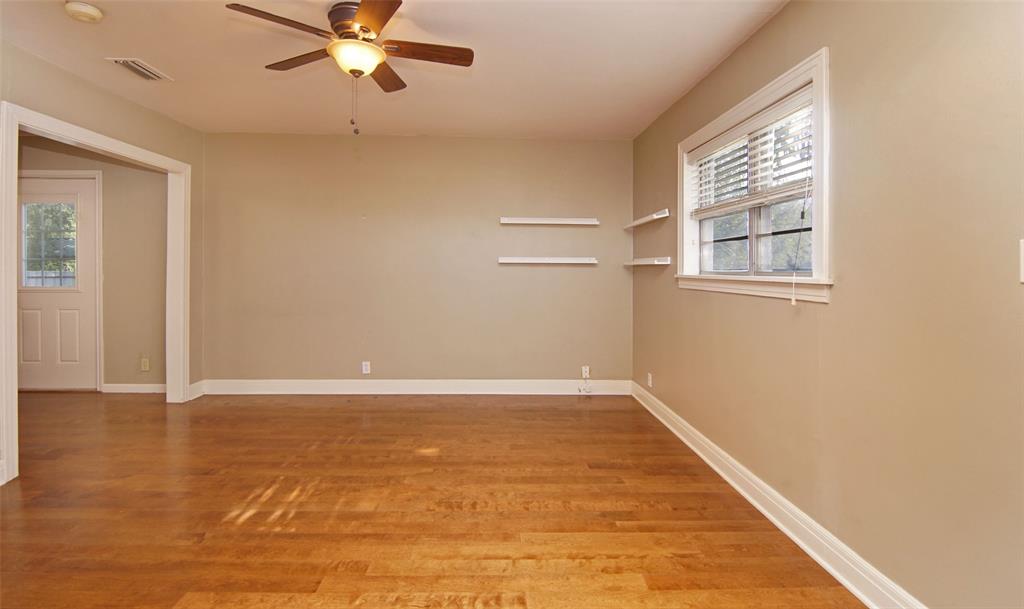 730 Indiana Street Graham, TX 76450 - Photo 16 of 25 a view of an empty room with wooden floor and a window
