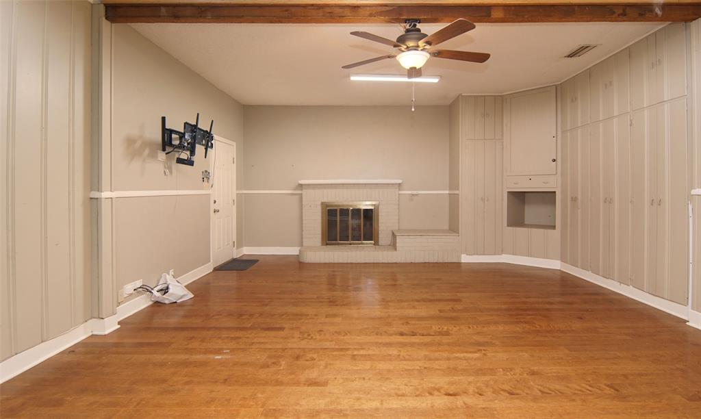 730 Indiana Street Graham, TX 76450 - Photo 7 of 25 a view of a livingroom with a fireplace and a chandelier fan