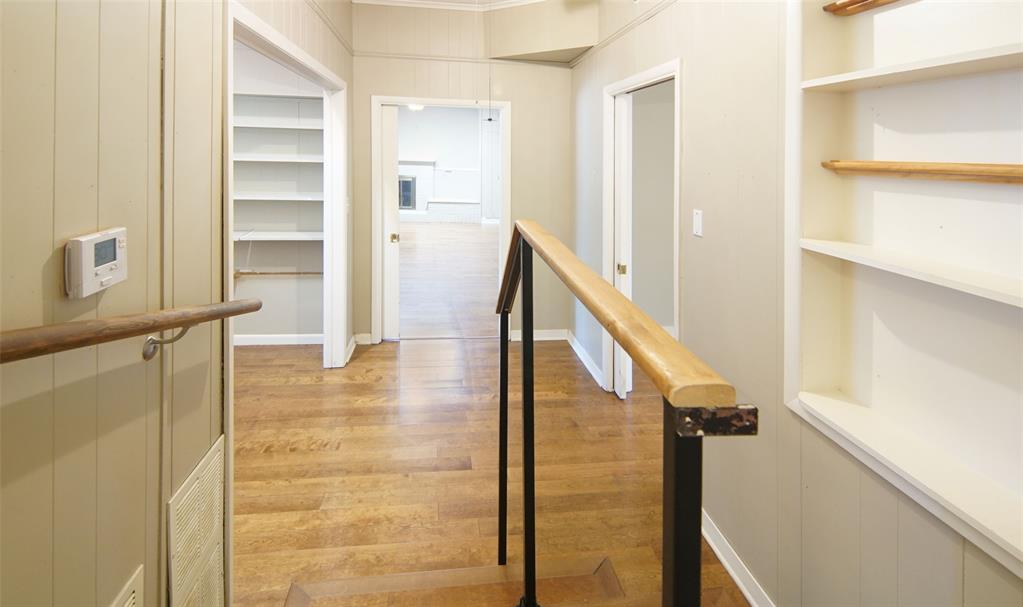 730 Indiana Street Graham, TX 76450 - Photo 10 of 25 a view of a hallway with wooden floor and staircase