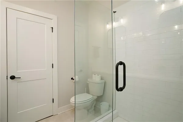 a bathroom with a shower a toilet and sink