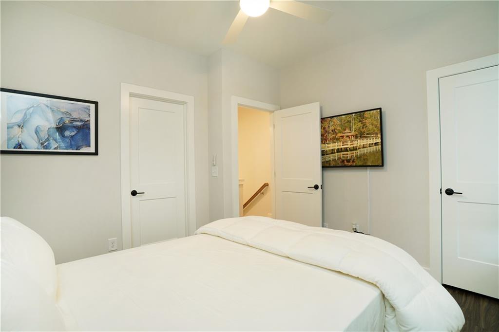 154 Chestnut Circle, Unit 80 Atlanta, GA 30342 - Photo 14 of 31 a bedroom with a bed and wall painting