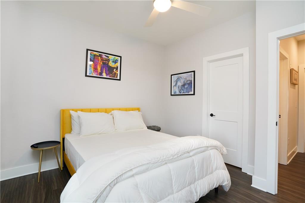 154 Chestnut Circle, Unit 80 Atlanta, GA 30342 - Photo 16 of 31 a bedroom with a bed and wooden floor