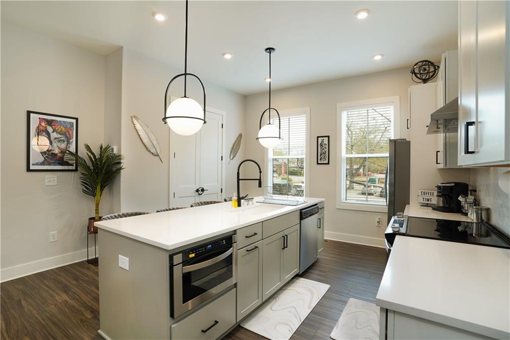 154 Chestnut Circle, Unit 80 Atlanta, GA 30342 - Photo 20 of 31 a kitchen with a sink a counter space and a view of living room