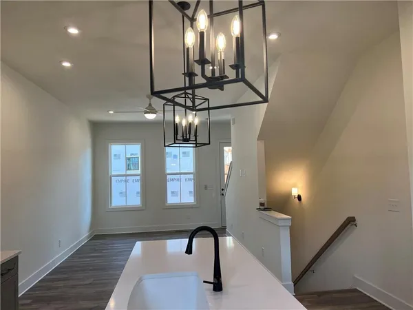 a view of entryway and hall with wooden floor