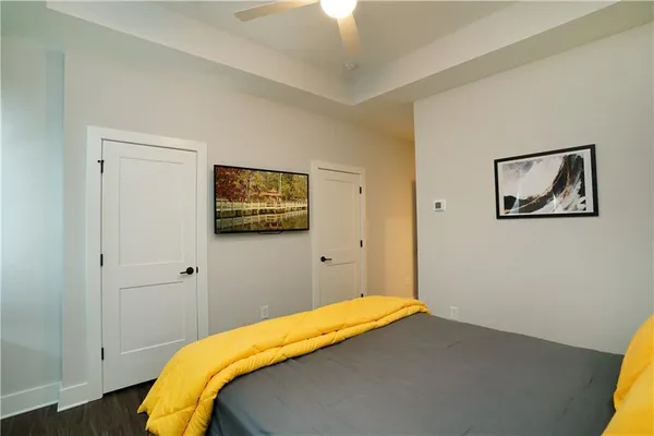 a bedroom with a bed and a painting on the wall