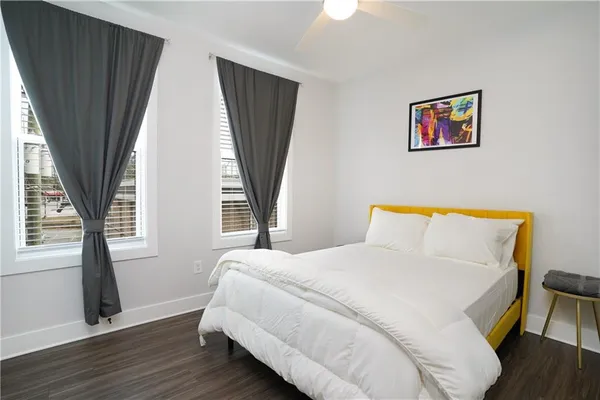 a bedroom with a bed and a large window