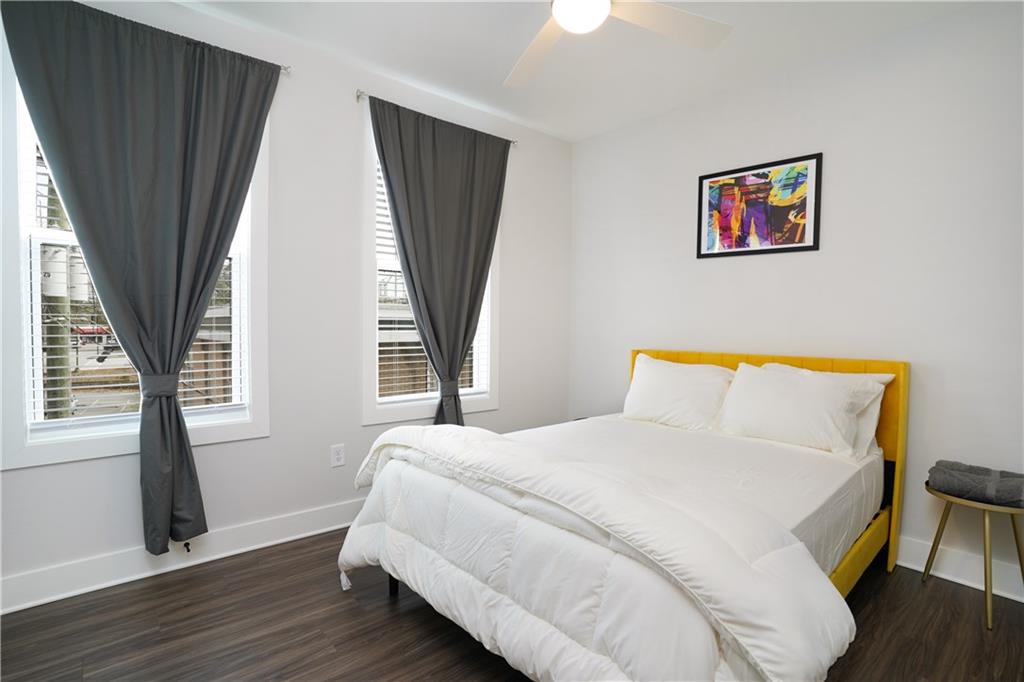 154 Chestnut Circle, Unit 80 Atlanta, GA 30342 - Photo 10 of 31 a bedroom with a bed and a large window