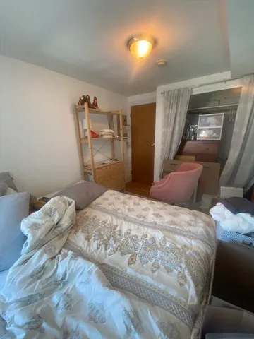 a bedroom with a bed and a tv