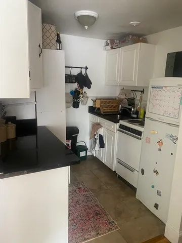 a kitchen with a sink and white cabinets