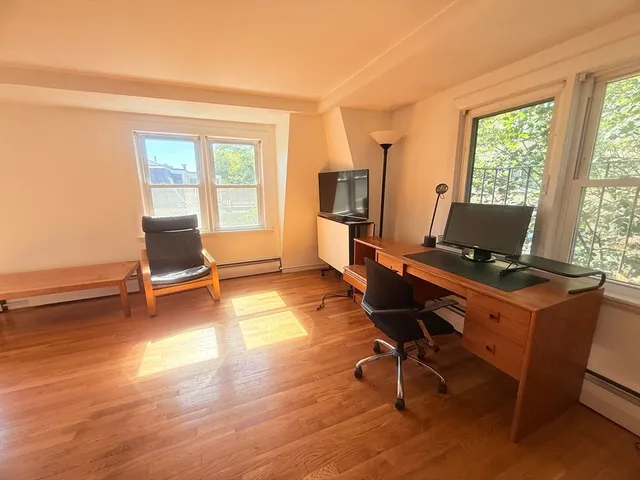 a view of workspace with wooden floor and windows