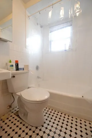 a bathroom with a toilet a sink and a bathtub