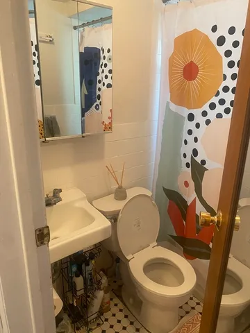a bathroom with a sink toilet and mirror