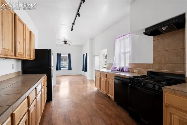 a kitchen with granite countertop a stove and a refrigerator