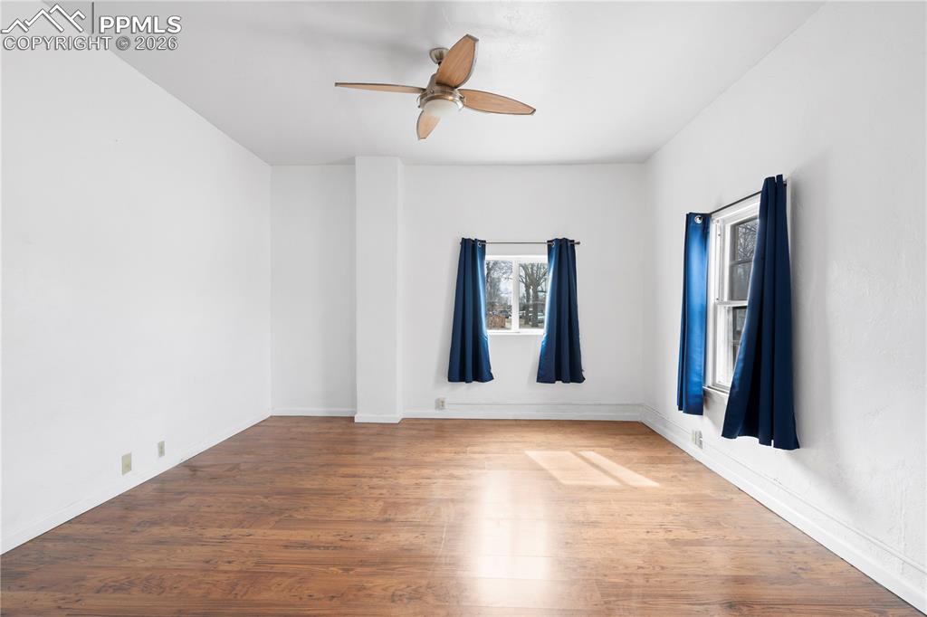 2232 East Routt Avenue Pueblo, CO 81004 - Photo 7 of 21 a view of an empty room with window and wooden floor