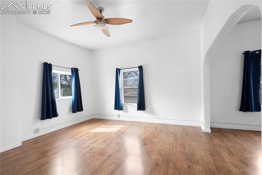 2232 East Routt Avenue Pueblo, CO 81004 - Photo 8 of 21 a view of an empty room with window and wooden floor