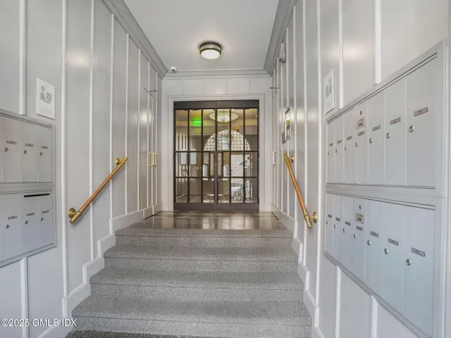 a view of staircase with white walls and windows