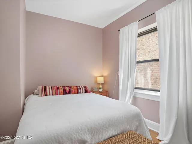 a bedroom with a bed and a window in it