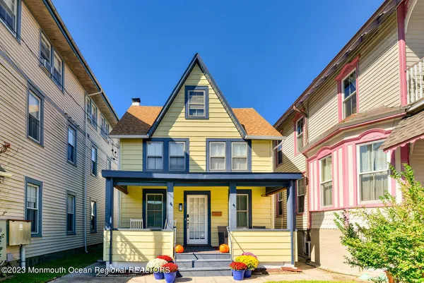 a view of front of house with car parked on the road