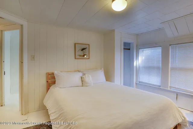 a bedroom with a bed and a lamp