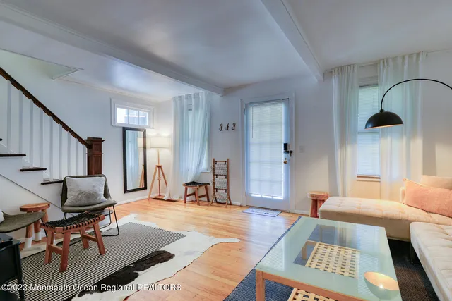 a living room with furniture rug and window