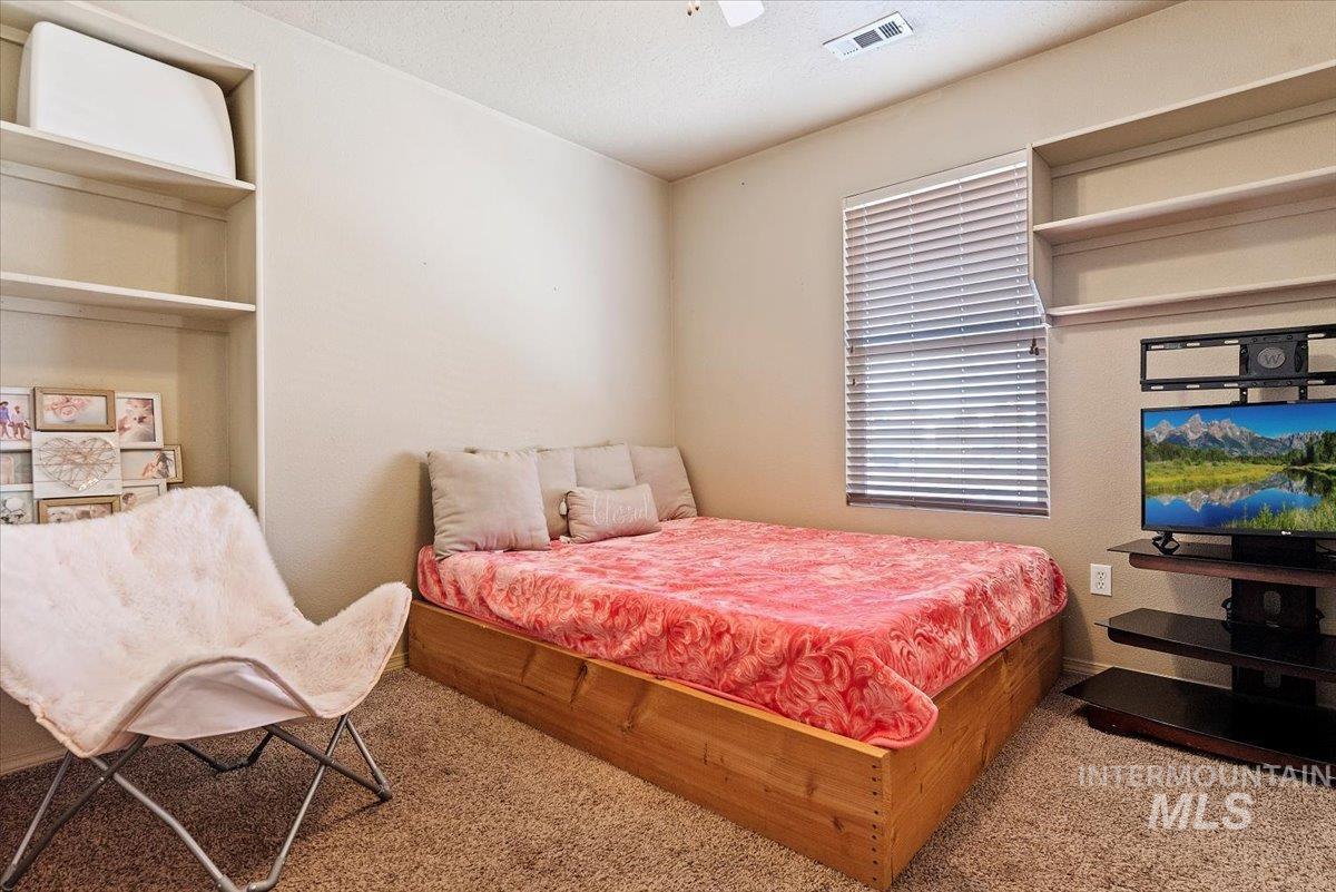 14057 Santa Cruz Street Caldwell, ID 83607 - Photo 14 of 26 Bedroom with carpet flooring, a textured ceiling, and ceiling fan