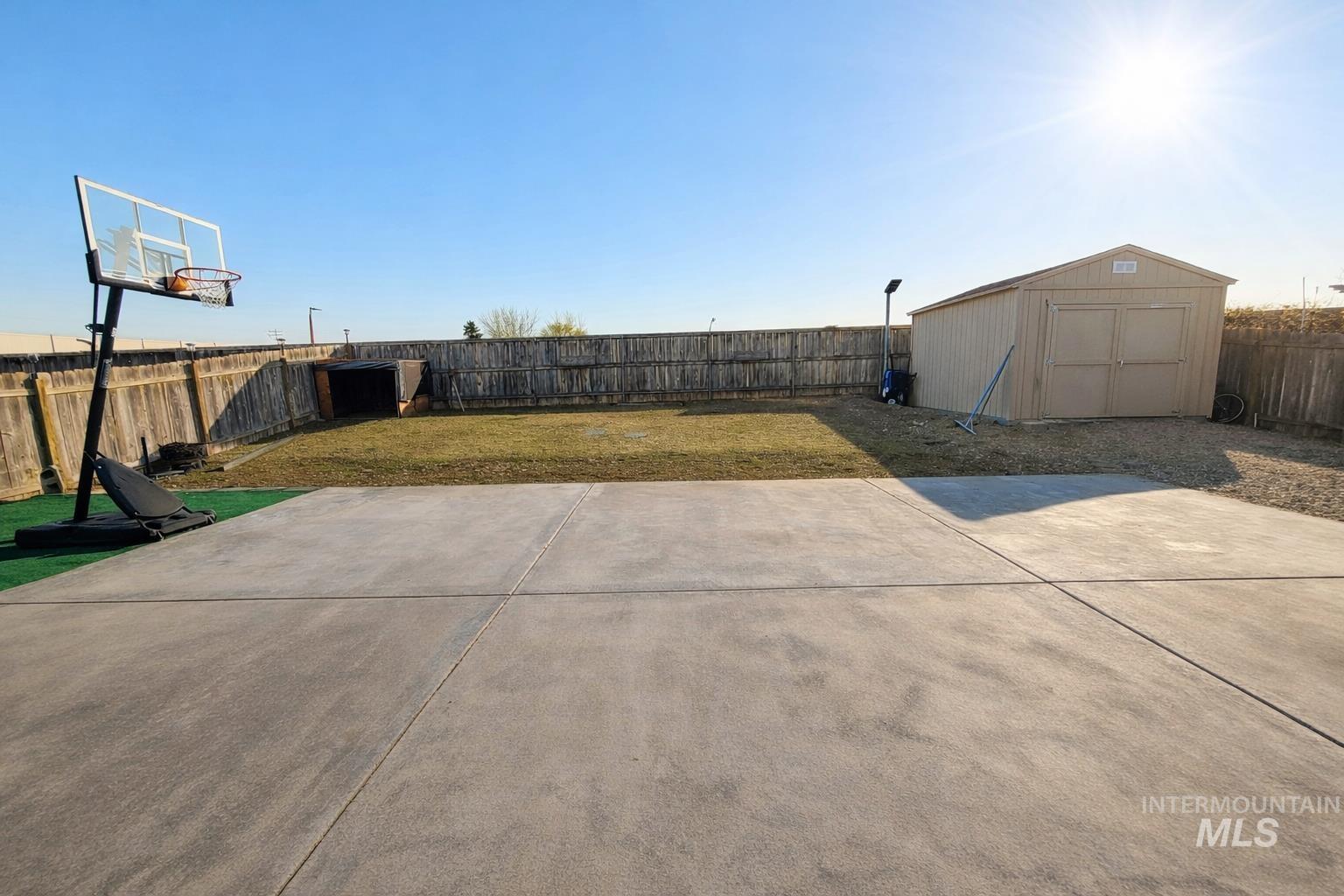 14057 Santa Cruz Street Caldwell, ID 83607 - Photo 22 of 26 Fenced backyard featuring a storage shed and a patio