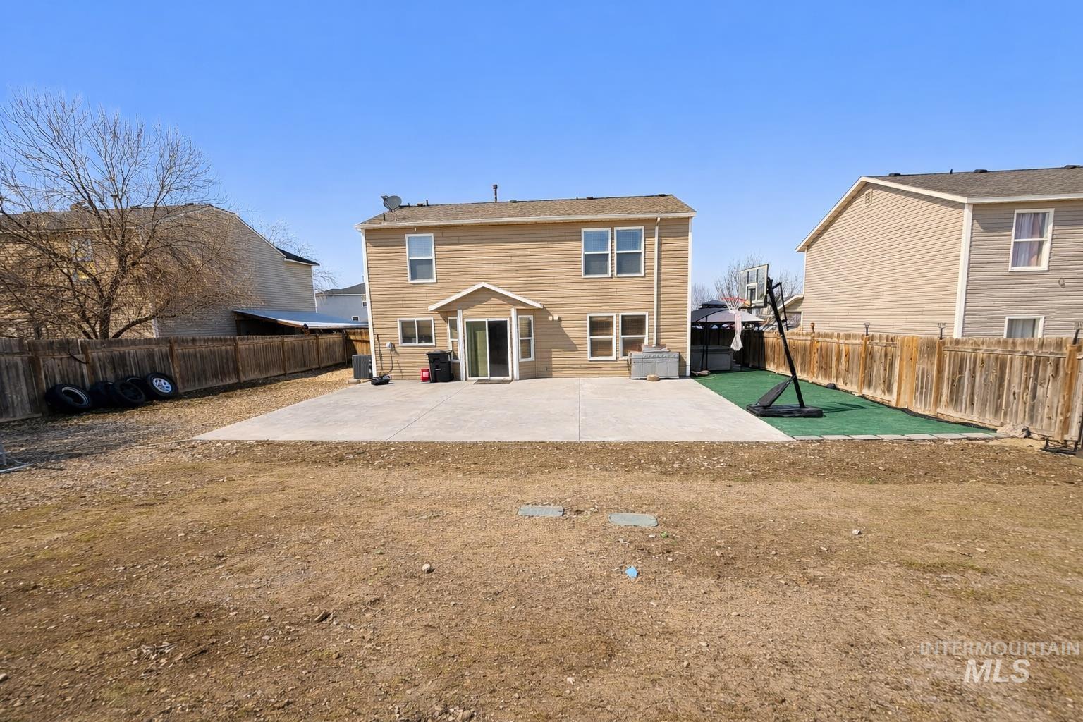 14057 Santa Cruz Street Caldwell, ID 83607 - Photo 23 of 26 Back of property featuring a patio and a fenced backyard