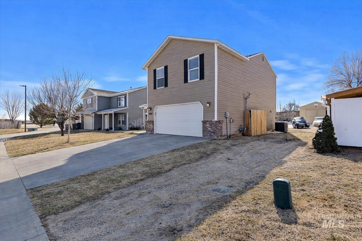 14057 Santa Cruz Street Caldwell, ID 83607 - Photo 3 of 26 View of front of property with driveway, covered porch, and an attached garage