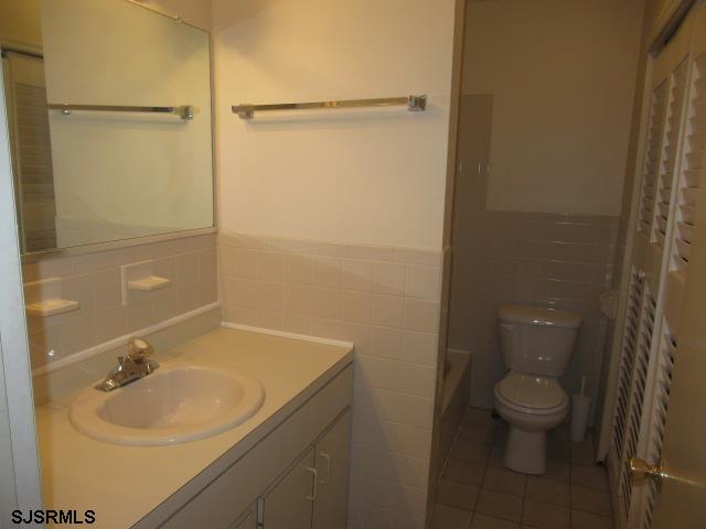 4 Oyster Bay, Unit 4K Absecon, NJ 08201 - Photo 4 of 8 a bathroom with a sink toilet and shower