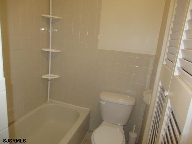 4 Oyster Bay, Unit 4K Absecon, NJ 08201 - Photo 5 of 8 a bathroom with a toilet and a shower