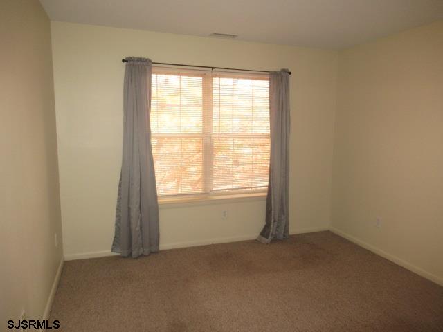 4 Oyster Bay, Unit 4K Absecon, NJ 08201 - Photo 6 of 8 an empty room with a window