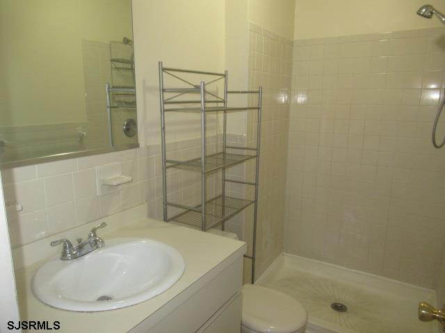 4 Oyster Bay, Unit 4K Absecon, NJ 08201 - Photo 8 of 8 a bathroom with a sink toilet and shower