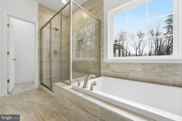 a bathroom with a bathtub and shower