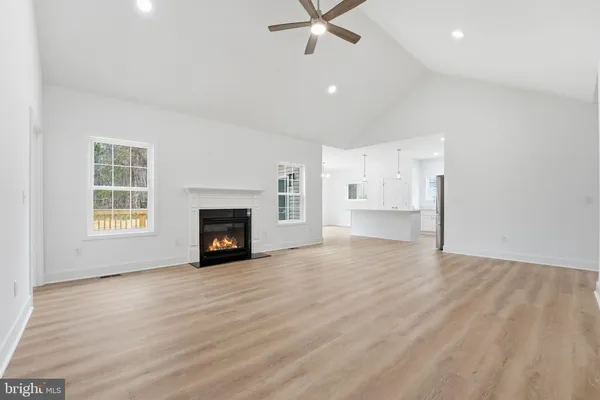 a view of empty room with a fireplace and window
