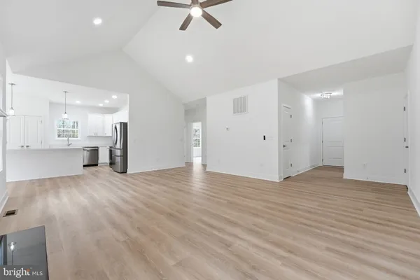 a view of a kitchen with a sink and a refrigerator