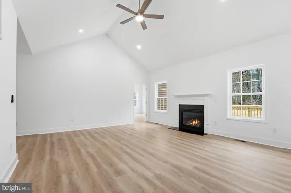 wooden floor in an empty room with a fireplace