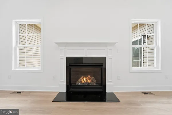 a living room with a fireplace and a window