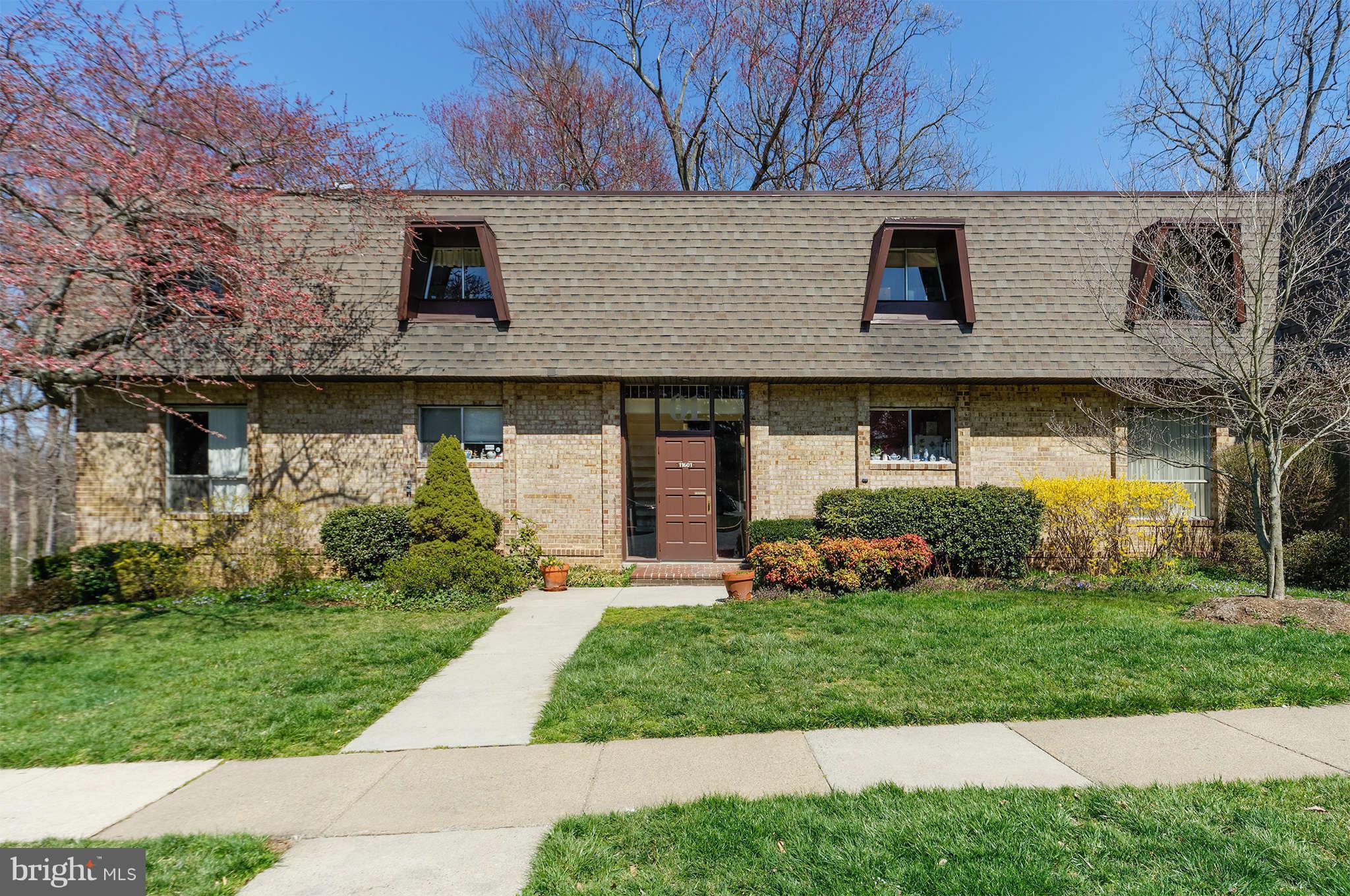 11601 Vantage Hill Road, Unit 1A Reston, VA 20190 - Photo 1 of 13 a front view of a house with a yard