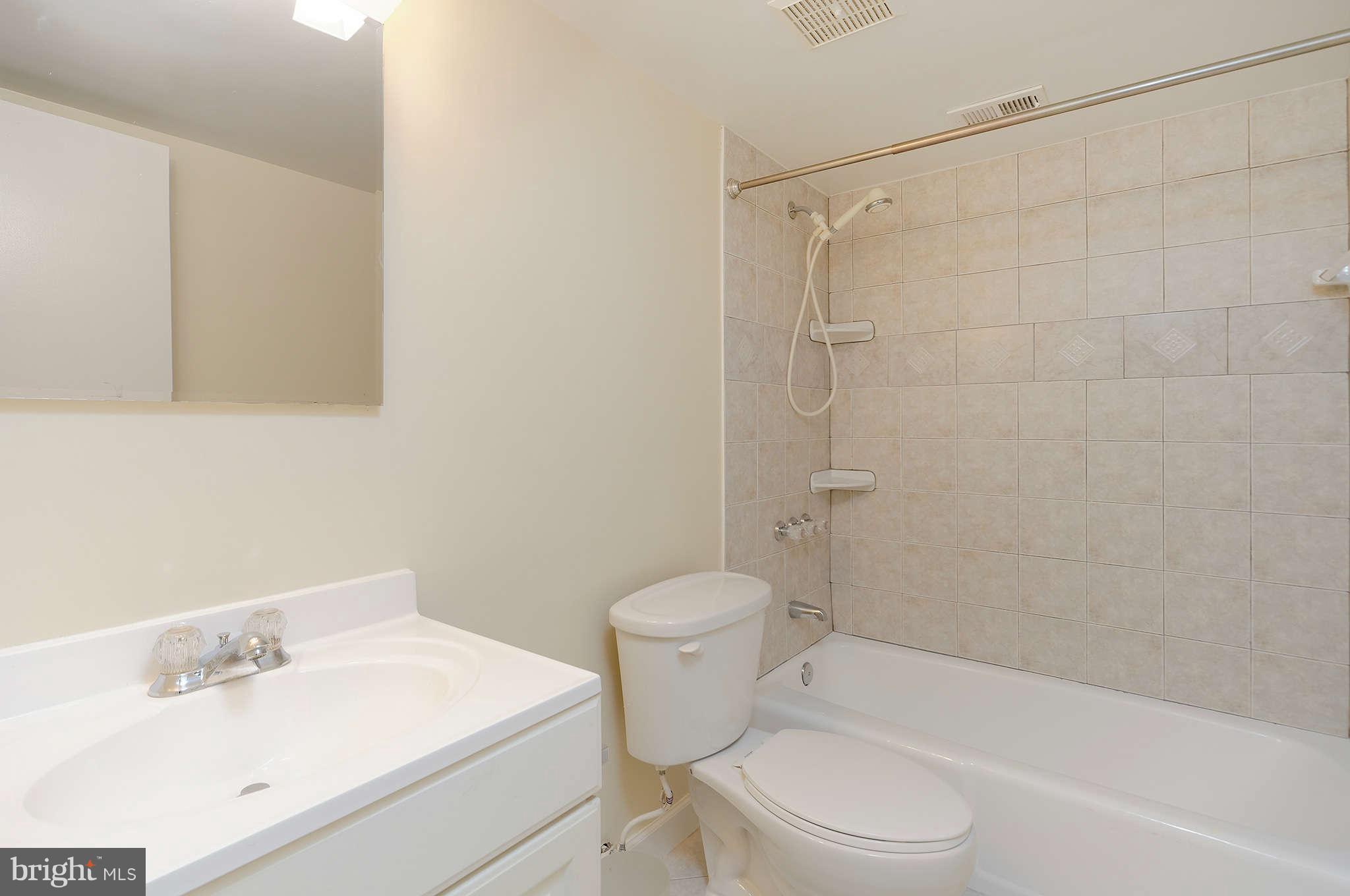 11601 Vantage Hill Road, Unit 1A Reston, VA 20190 - Photo 11 of 13 a bathroom with a sink toilet and shower
