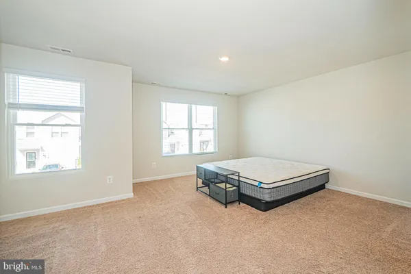 a room with a bed and window