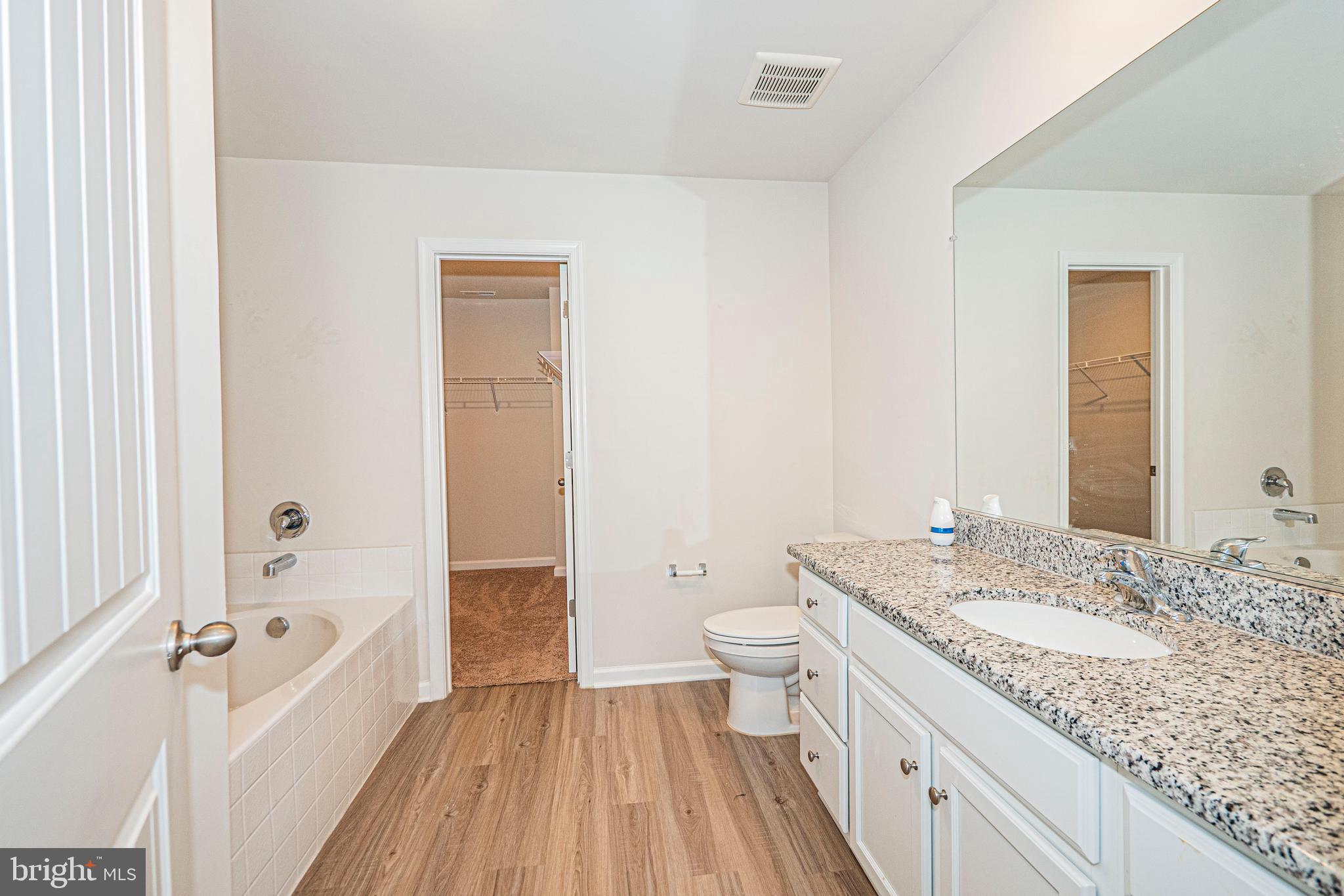 120 Paddington Street Falling Waters, WV 25419 - Photo 18 of 34 a bathroom with a granite countertop sink a toilet and bathtub